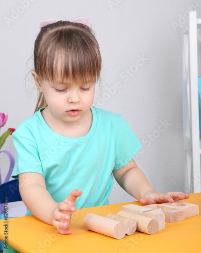 Little girl plays with cons...