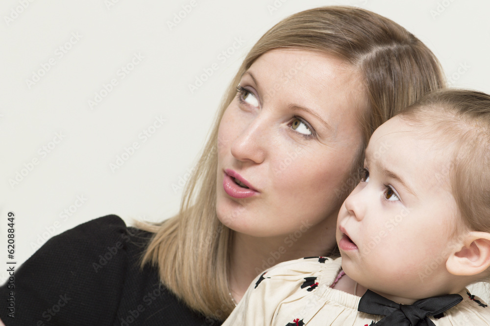 The mother withs the daughter is looking up. The mother withs the daughter is looking up.