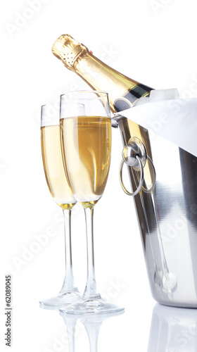 Glasses of champagne and bottle in pail, isolated on white