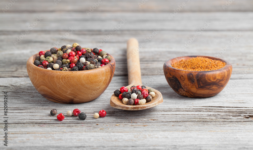 Colored Pepper in the wooden bowl, on wooden board Colored Pepper in the wooden bowl, on wooden board