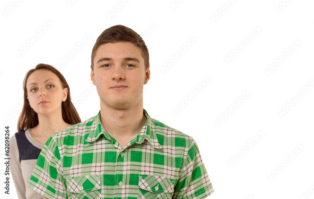 Smug young man being watched by his girlfriend Smug young man being watched by his girlfriend