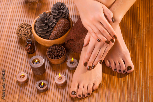 brown manicure and pedicure on the bamboo © Dmytro Titov