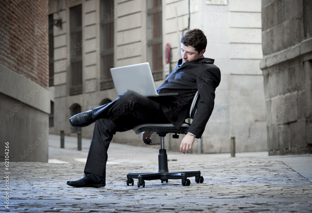 Tired Business Man sitting on Office Chair on Street sleeping Tired Business Man sitting on Office Chair on Street sleeping