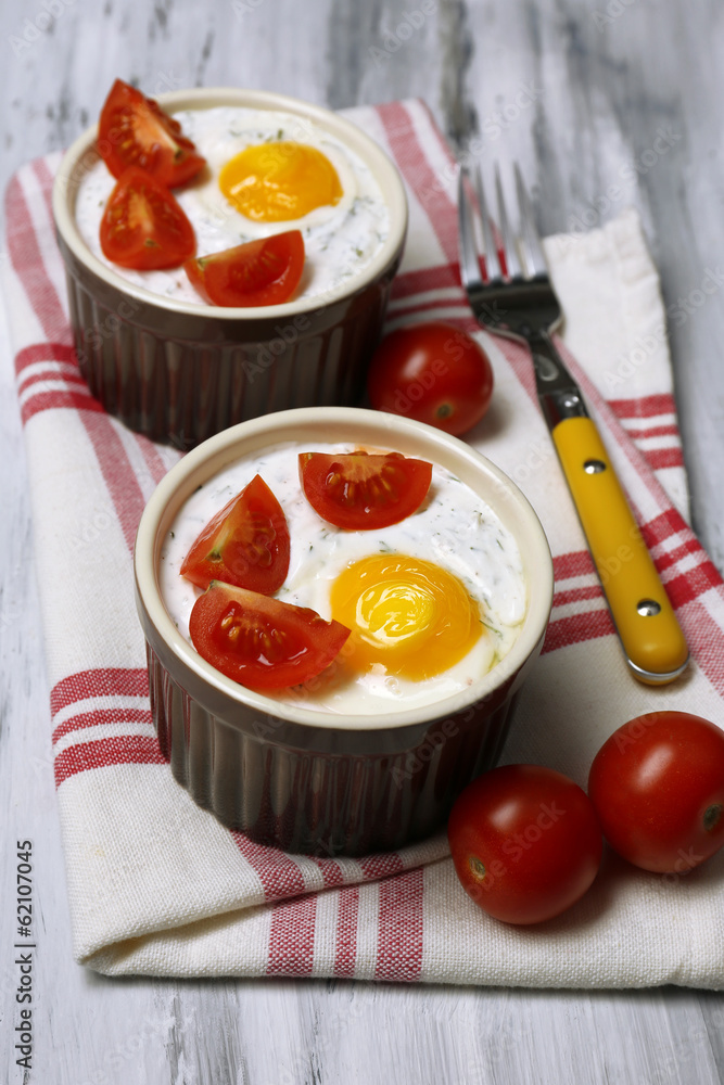 Baked eggs on wooden table close up Baked eggs on wooden table close up