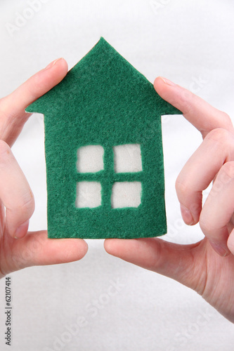 Little paper house in hand close-up