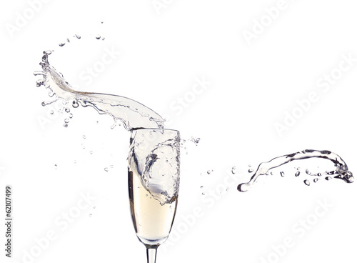 Glass of champagne with splash, isolated on white