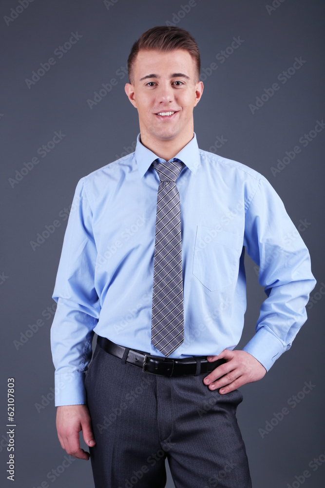 Fototapeta premium Handsome young man on gray background