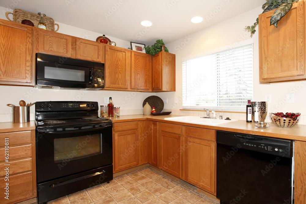 Brown kitchen cabinets with black appliances Brown kitchen cabinets with black appliances