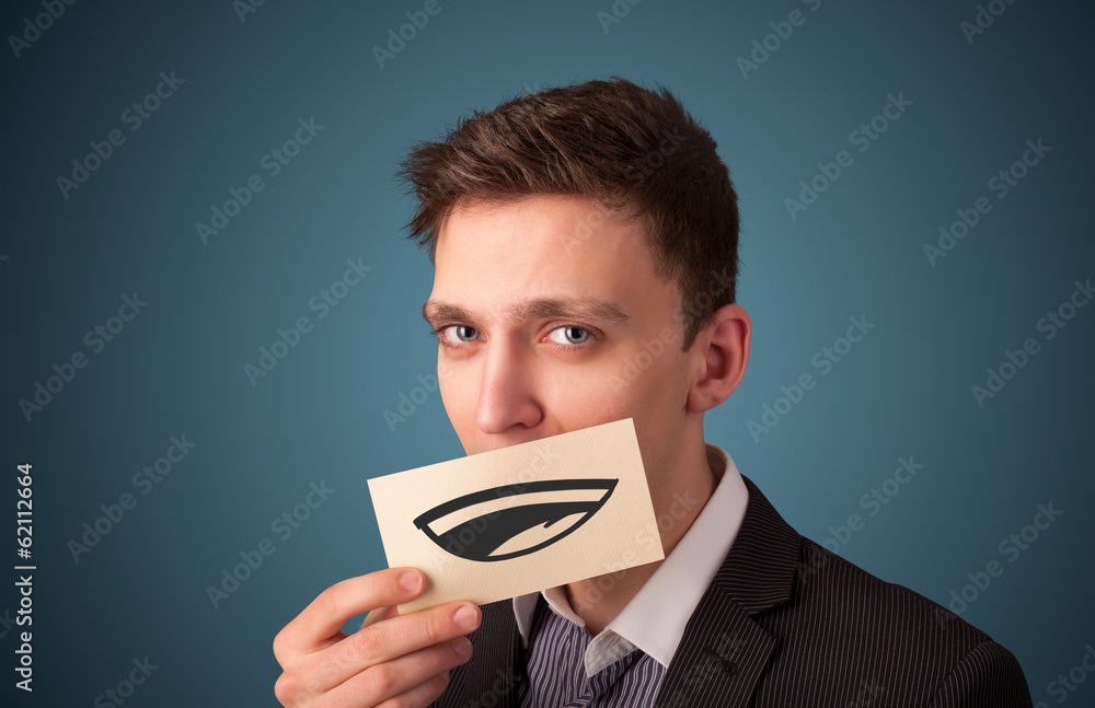Happy businessman holding funny white card on his mouth Happy businessman holding funny white card on his mouth