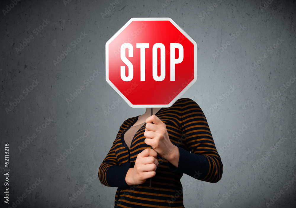 Young woman holding a stop sign Young woman holding a stop sign