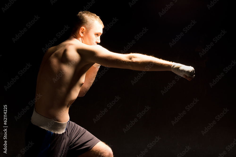 Boxer making a jabbing punch during a boxing match Boxer making a jabbing punch during a boxing match