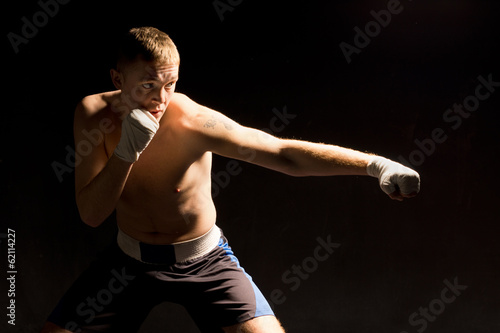 Pugnacious young boxer throwing a punch