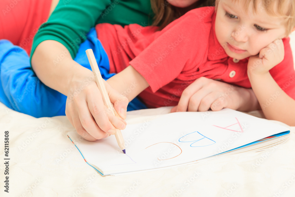 hands of mother and child writing letters hands of mother and child writing letters
