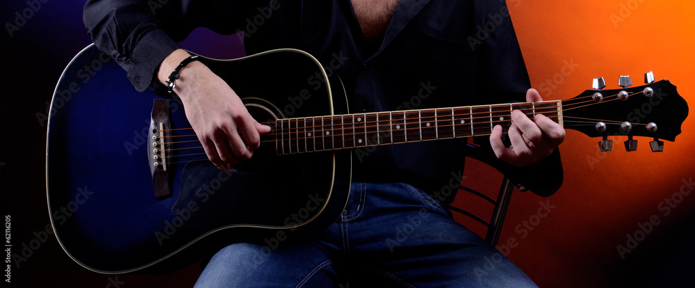 Fototapeta premium Young musician playing acoustic guitar and singing,