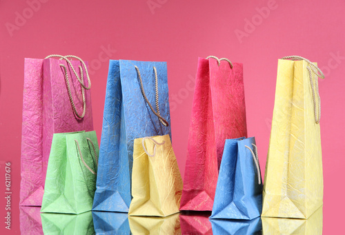 Colorful shopping bags, on color background