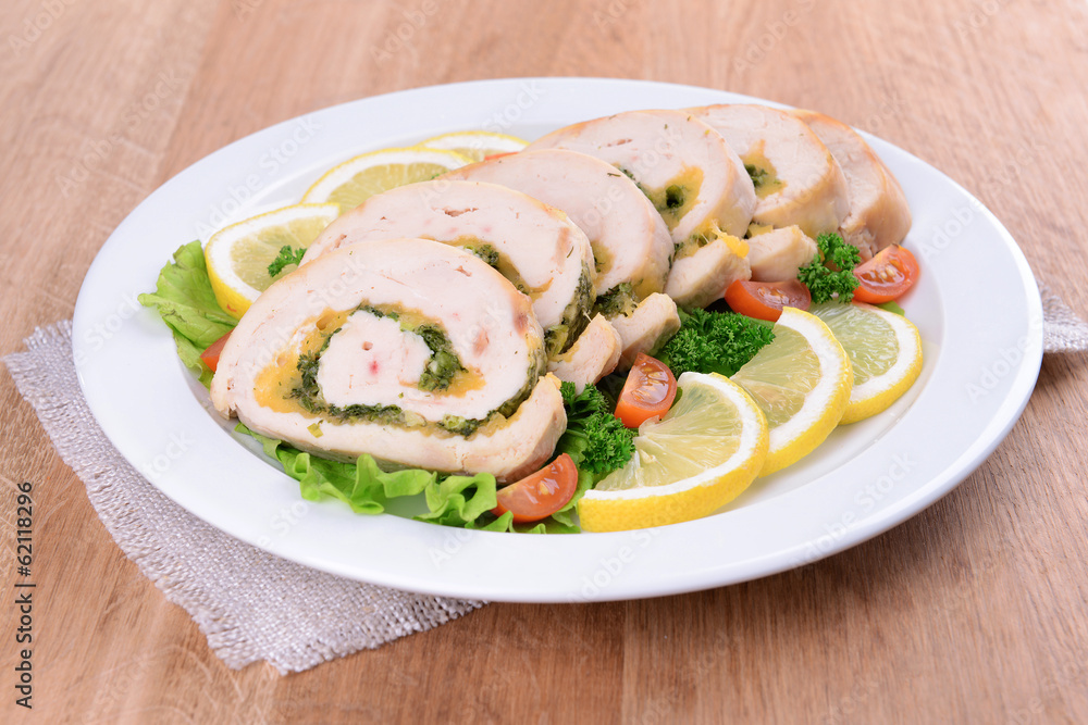 Delicious chicken roll on plate on table close-up Delicious chicken roll on plate on table close-up