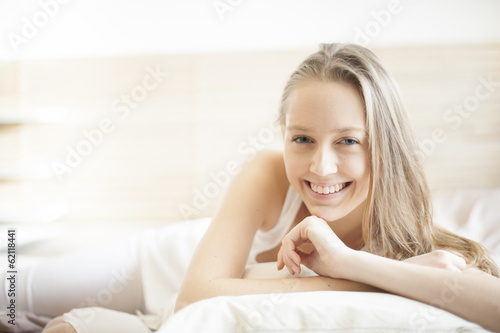portrait of a beautiful young woman in her bedroom