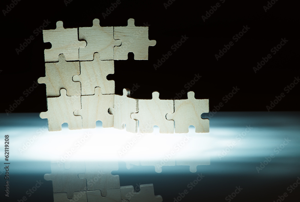 Fototapeta premium Wooden puzzle and backlight background. Close up