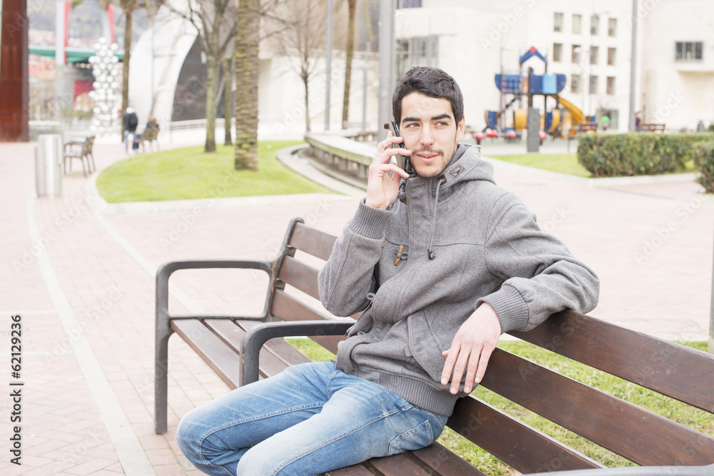 Man talking on the phone in the street.