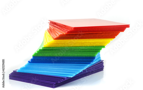 Stack of colorful  corrugated plastic sheets photo