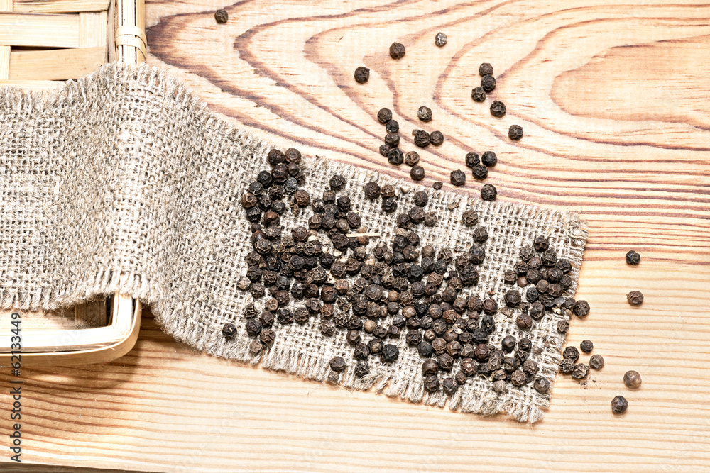 Black pepper is scattered on the wooden table Black pepper is scattered on the wooden table