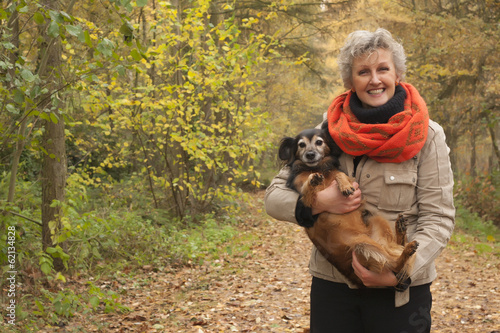 Middle aged woman is carry the dog