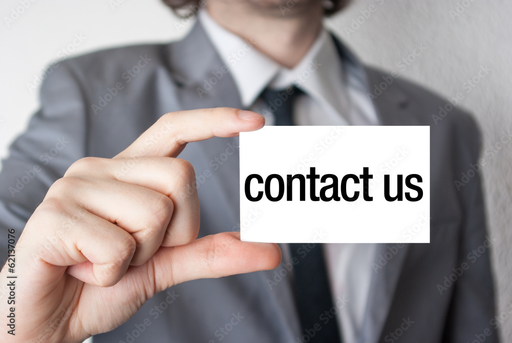 Contact us. Businessman in suit with a black tie showing or hold Contact us. Businessman in suit with a black tie showing or hold