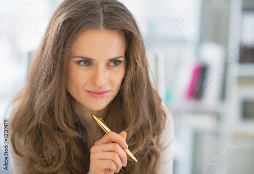 Portrait of thoughtful business woman in office