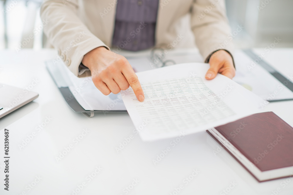 Closeup on business woman pointing on document Closeup on business woman pointing on document