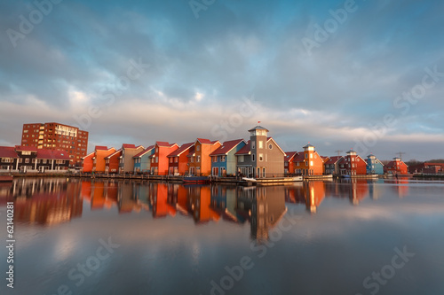 colorful buildings on water in morning sunlight