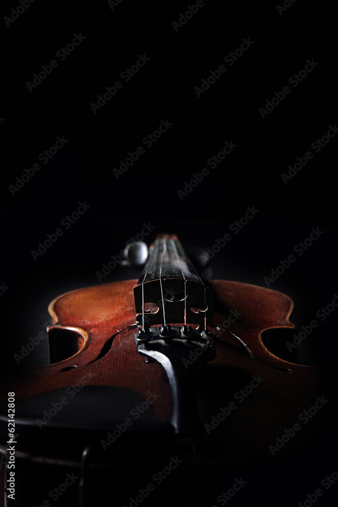 Fototapeta premium Old violin on dark background. Closeup view.