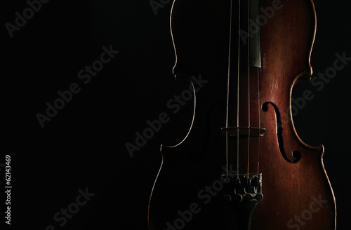 Old violin on dark background