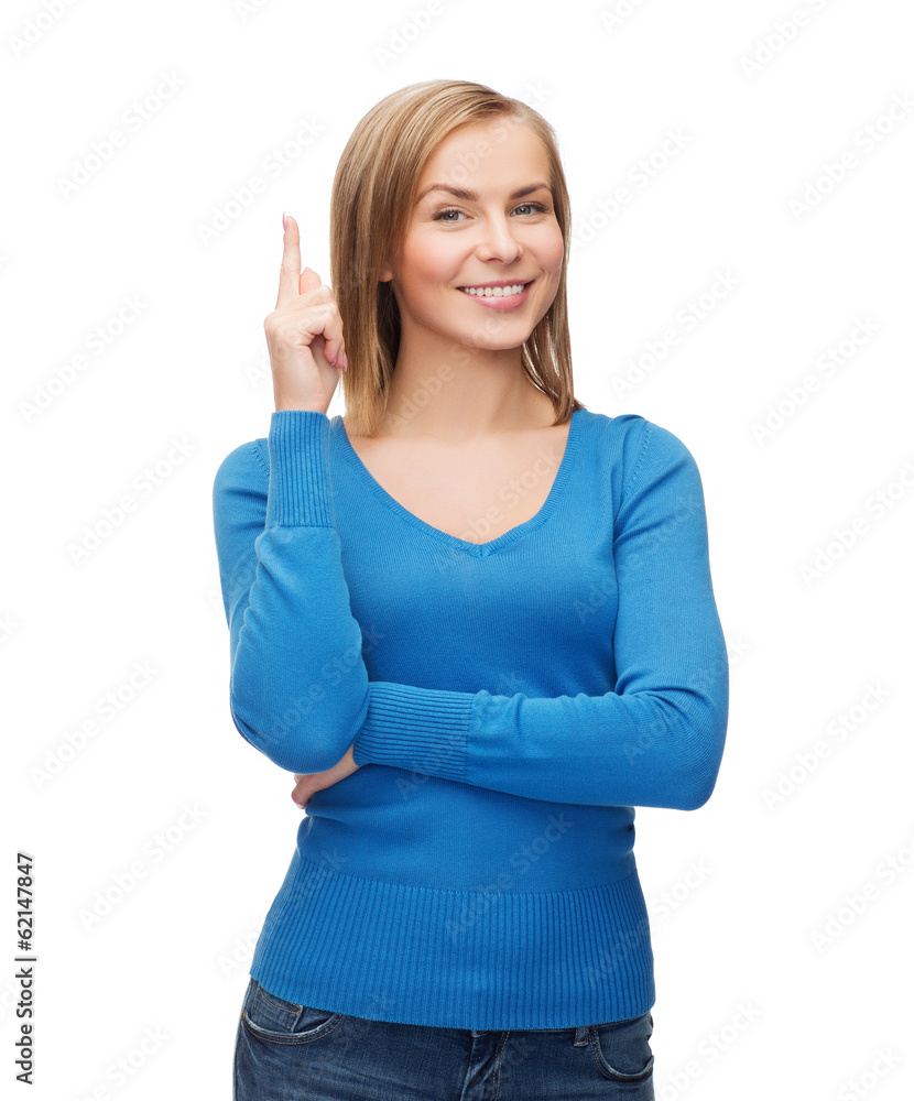 smiling woman pointing her finger up smiling woman pointing her finger up