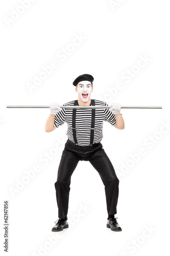 Mime artist holding a big metal pipe