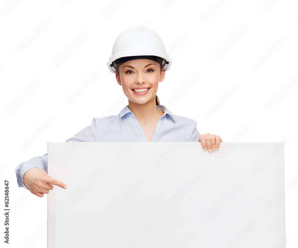 businesswoman in helmet pointing finger to board businesswoman in helmet pointing finger to board