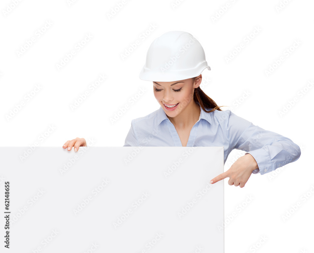 businesswoman in helmet pointing finger to board businesswoman in helmet pointing finger to board