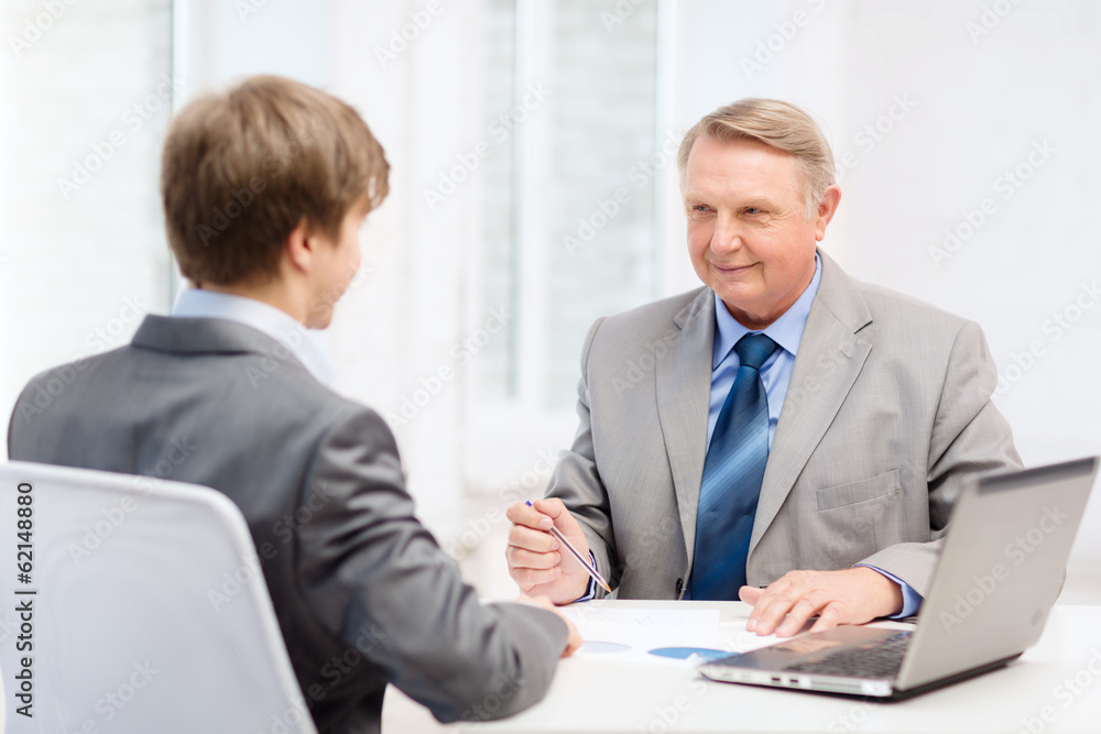 older man and young man having meeting in office older man and young man having meeting in office