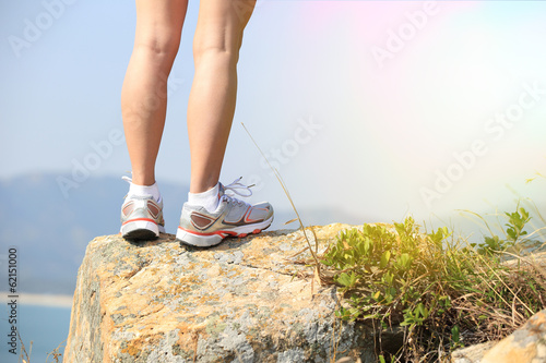  hiking feet stand at seaside mountain peak rock