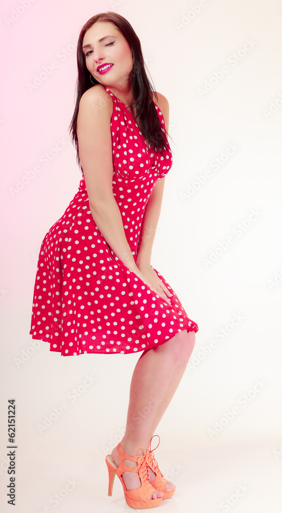 Full length pinup girl woman in retro red dress winking. Full length pinup girl woman in retro red dress winking.