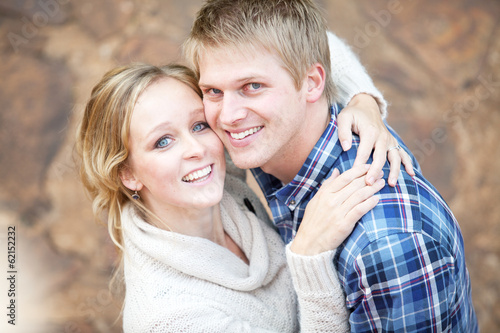 Young couple in love looking up at viewer