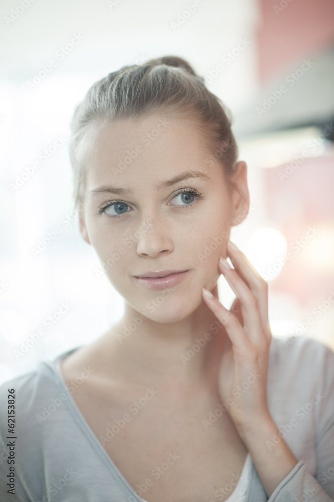 closeup of a beautiful young woman looking herself in a mirror closeup of a beautiful young woman looking herself in a mirror