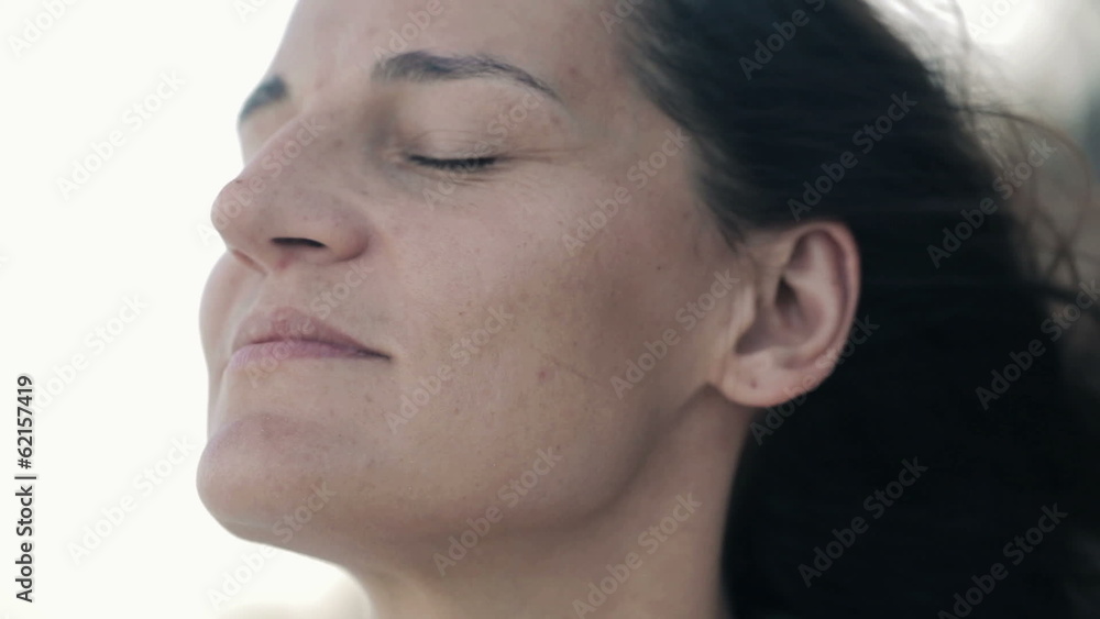 Face of happy, content woman enjoying breeze Face of happy, content woman enjoying breeze