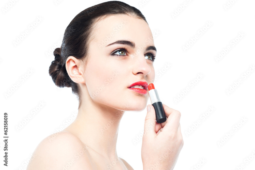 Young gorgeous woman applying lipstick Young gorgeous woman applying lipstick