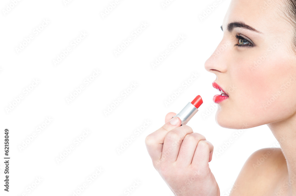 Attractive teen girl applying red lipstick Attractive teen girl applying red lipstick