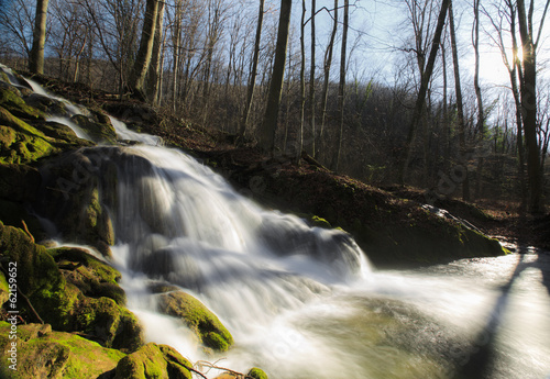 Mountain stream and waterfalls in the forest in spring