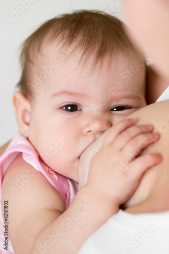 mother breast feeding her i...
