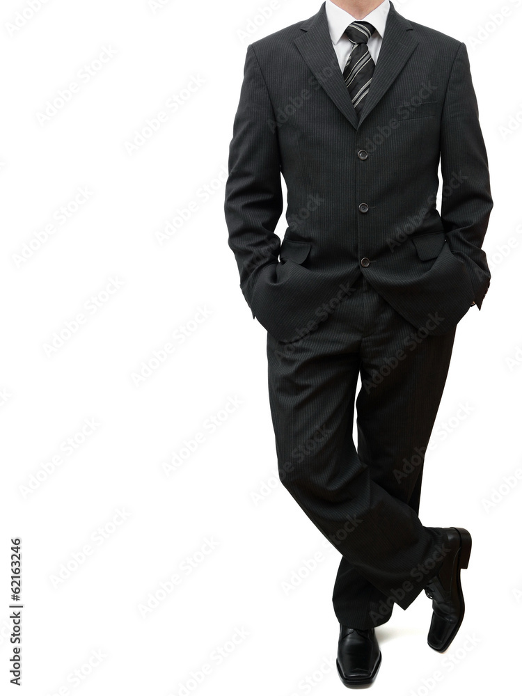 business man standing with legs crossed and both hands in his po business man standing with legs crossed and both hands in his po