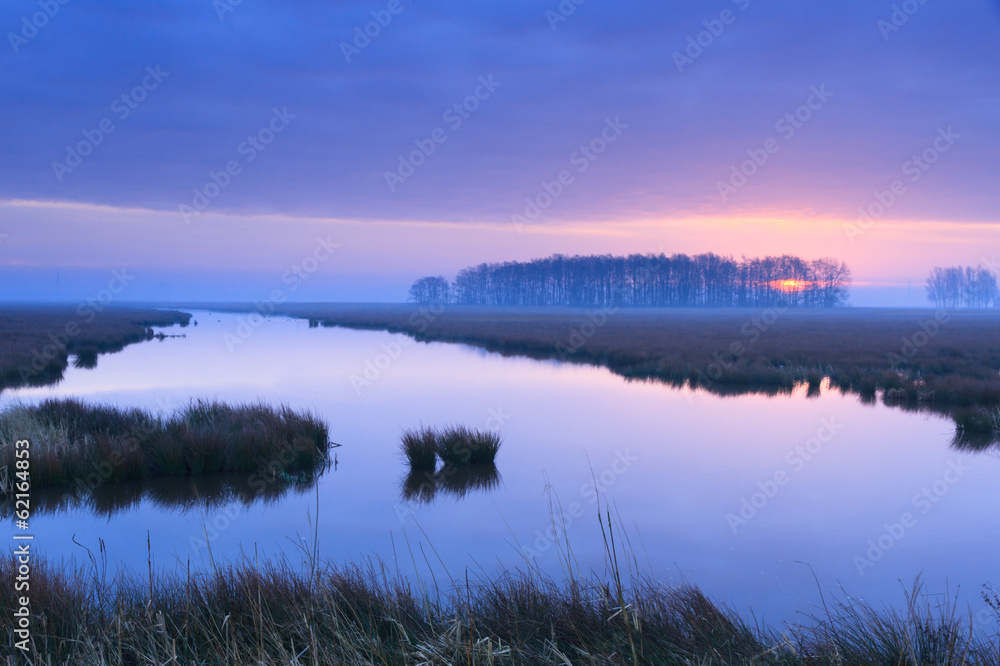 Fototapeta premium Purple, spring sunrise at a river.