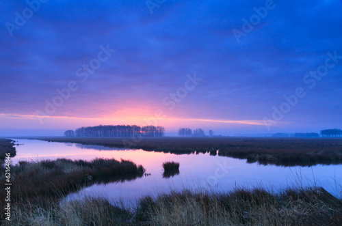 Purple, spring sunrise at a river.