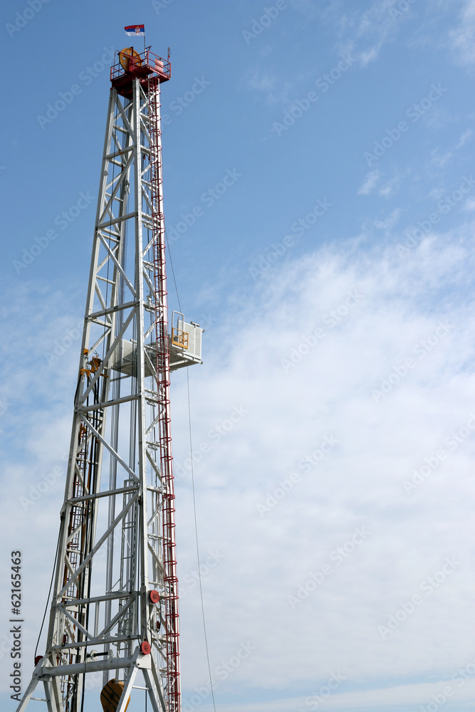oil drilling rig tower on blue sky